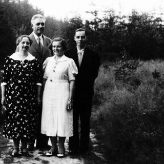 Family portrait outdoors in early 20th-century clothing.