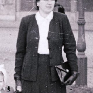 Three women walking together outdoors in 1940s-era clothing.