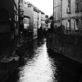 Narrow canal flanked by old buildings.