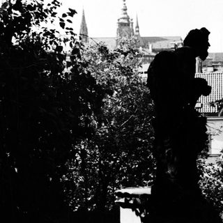 Silhouette of person against historic cathedral spires.