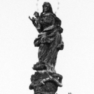 Baroque-style fountain monument with statues in urban setting.