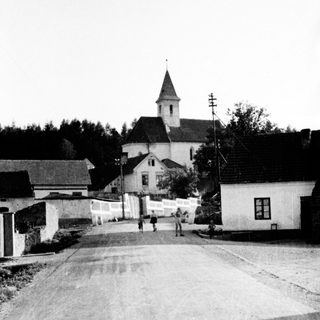 Black and white photo of a village with a church.