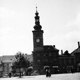 Black and white photo of a town square and building.