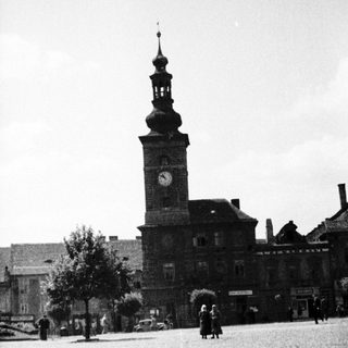 Black and white photo of a town square and building.