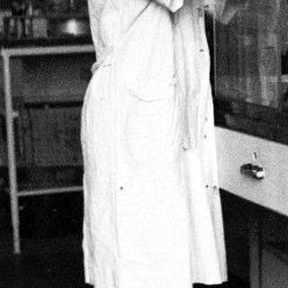 Scientist working in a lab, using lab equipment.