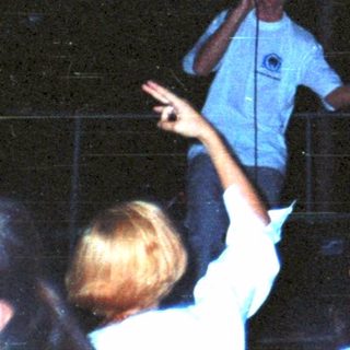 Here's a brief summary: Men on stage performing for a crowd.