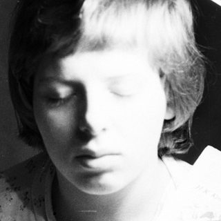 Here's a brief summary of the image: Young woman's portrait with a graphic overlay.