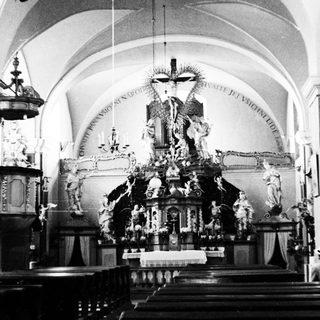Interior of a church featuring a large, ornate altar.