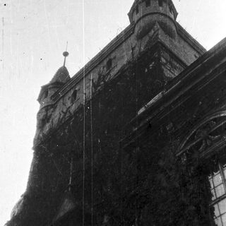 Black and white image of an old building with towers.