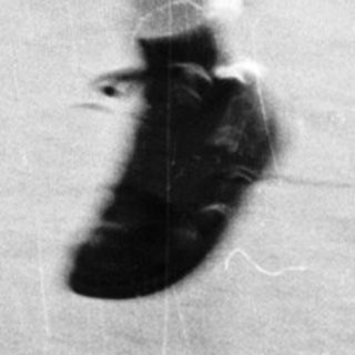 Young girl runs, blurred motion, outdoor setting.