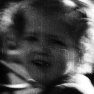 Young girl runs, blurred motion, outdoor setting.