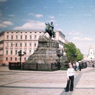 Monument and cityscape with a person standing in the foreground.