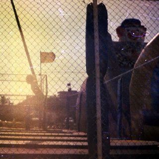 An old, faded photo shows a clown statue and carnival.