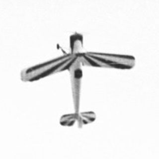 Here's a brief summary: Airplane flying in a bright, overcast sky.