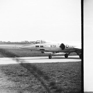 Vintage black and white image of a military jet on runway.