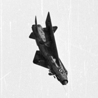 F-86 Sabre jet aircraft in flight, black and white.