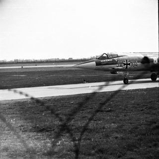 Black and white image of a jet on a runway.