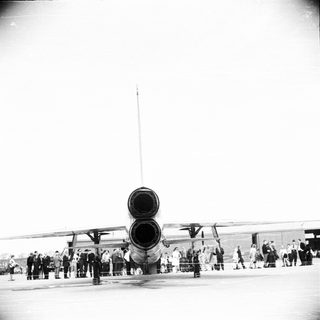 USAF B-52 bomber on display, people observing.
