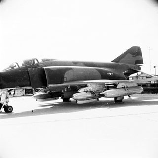 F-4 Phantom fighter jet sits on an airfield.