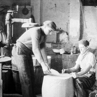 Two men working in a vintage laboratory setting.