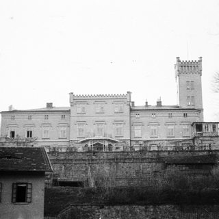 Black and white image of a large, historic stone building.