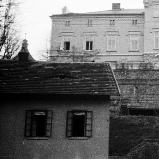 Black and white image of a large, historic stone building.