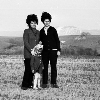 Black and white photo of a family in a field.