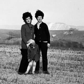 Black and white photo of a family in a field.