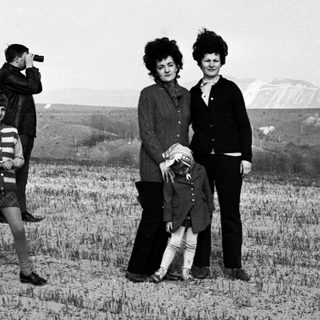 Black and white photo of a family in a field.