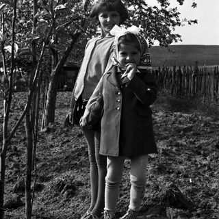 Black and white photo of a woman and young child outdoors.