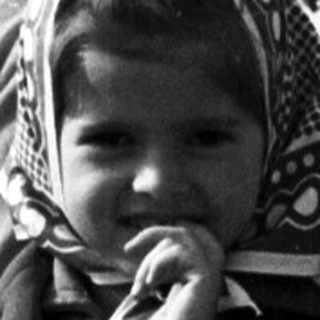 Black and white photo of a woman and young child outdoors.
