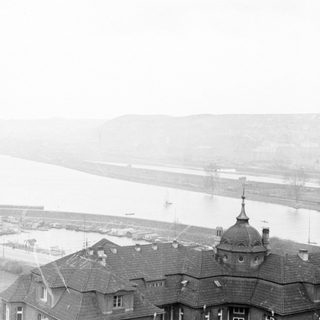 A city overlooking a river with a bridge.