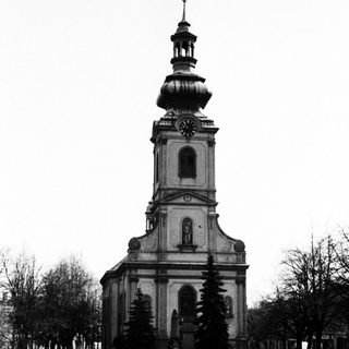 Black and white photograph of a church with a tall tower.