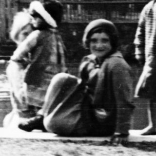 Children gathered near a body of water, possibly a canal.