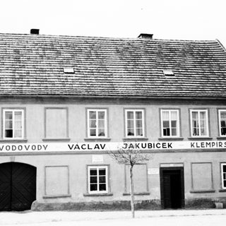 Black and white photo of a building with signage.