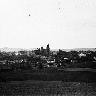 Black and white photograph of a town with prominent church spires.