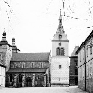 Black and white image of a stone church and buildings.