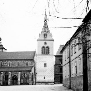 Black and white image of a stone church and buildings.