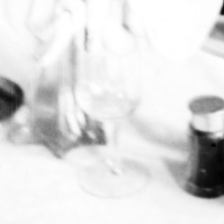 Table setting with wine bottles, glasses, and decorations.