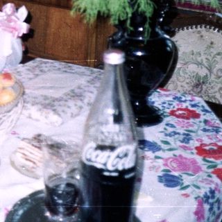 Couple and dog near a table with food and decor.