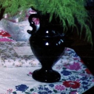 People share a meal with a dog at a table.