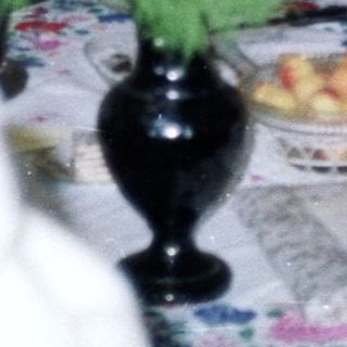 Two women at a table with a dog and decor.
