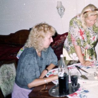 People and a rabbit at a table with food.