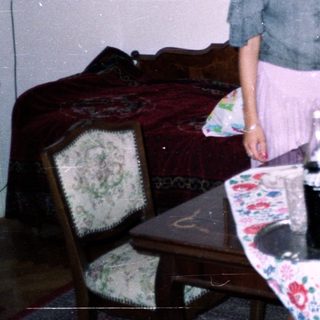 Two women standing near a table with food and decor.