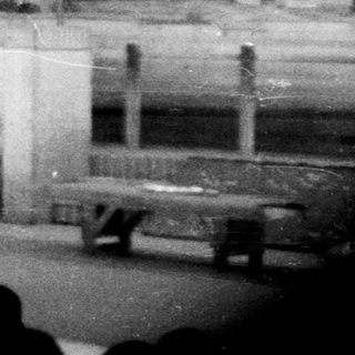 Stage set depicting a building with a performer on stage.