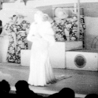 Stage performance with people in costumes and uniforms.