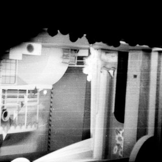 Stage with backdrop, visible figures in the audience.