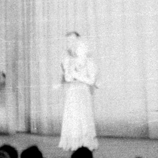 Stage scene featuring a performer and ornate backdrop.