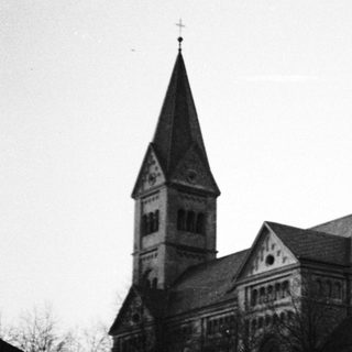 Black and white photograph of a stone church building.