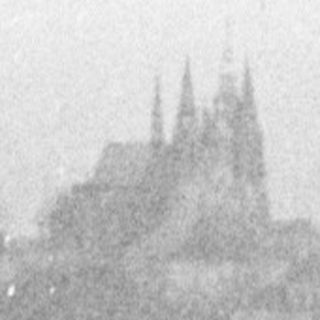 A hazy view of a city with a cathedral.